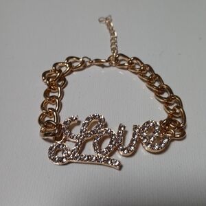 Brand new Gold Blinged Love sign bracelet